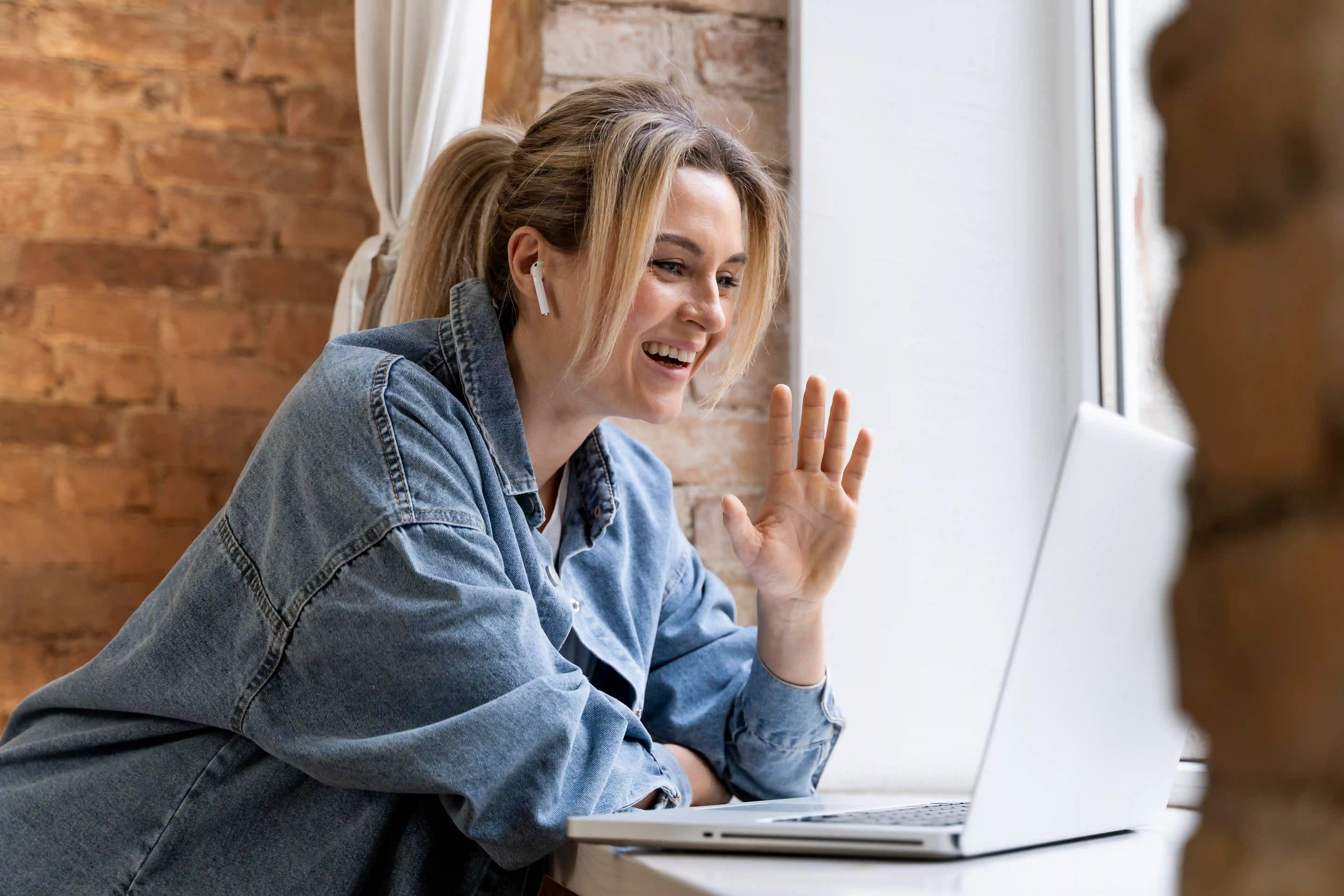 Person sitting on a couch with a laptop
